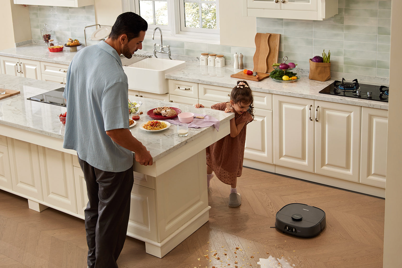 Parent and child watching a Eureka robot vacuum clean the living-room floor
